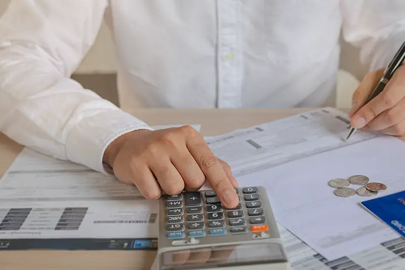 Businessman using calculator