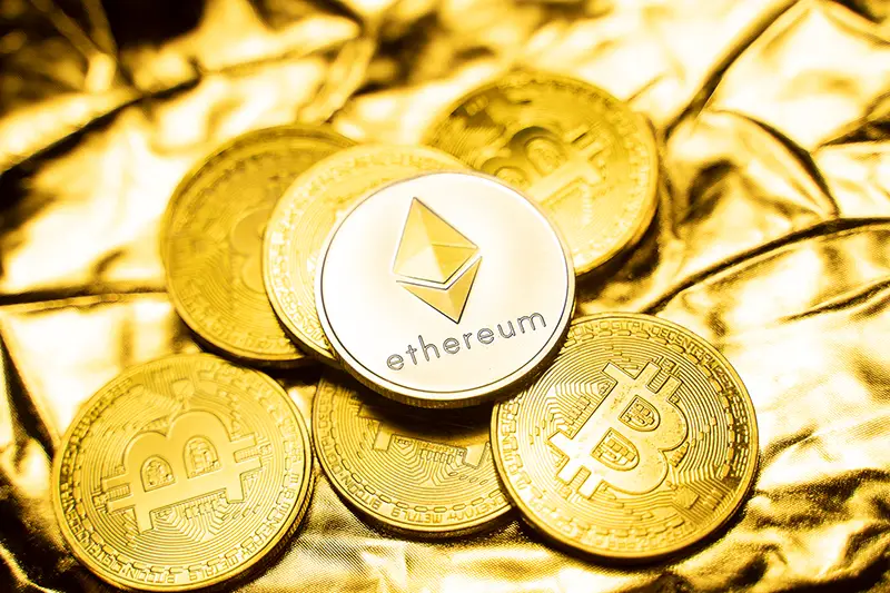 Gold ethereum coins on a golden background