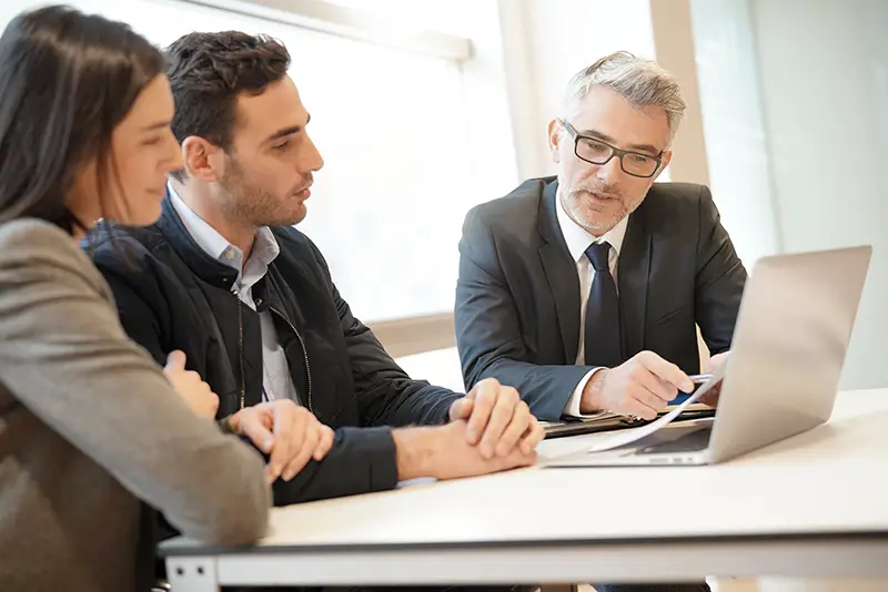 Young couple meeting financial advisor for home investment