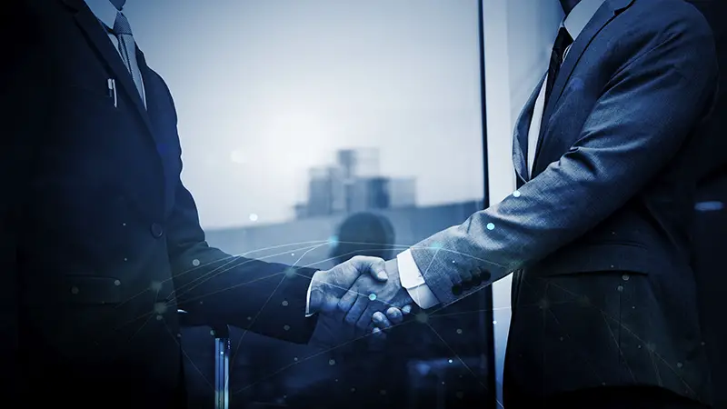 Business people shaking their hands