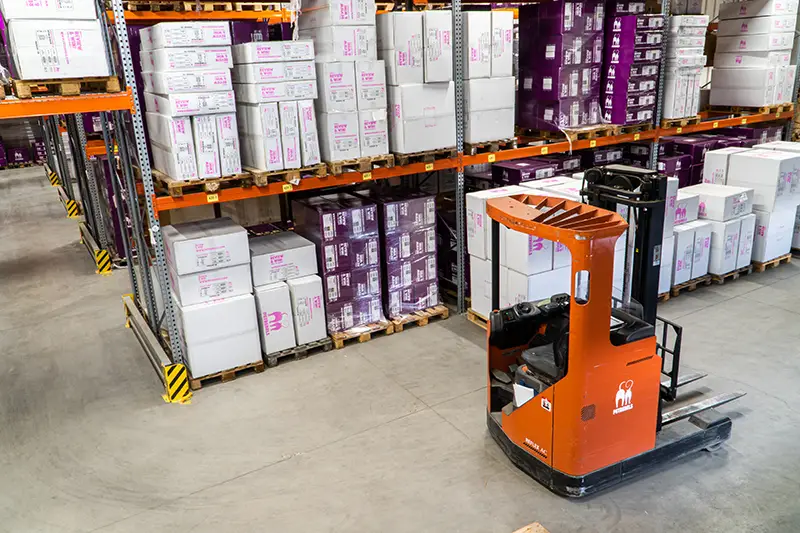 Orange and black forklift inside the warehouse