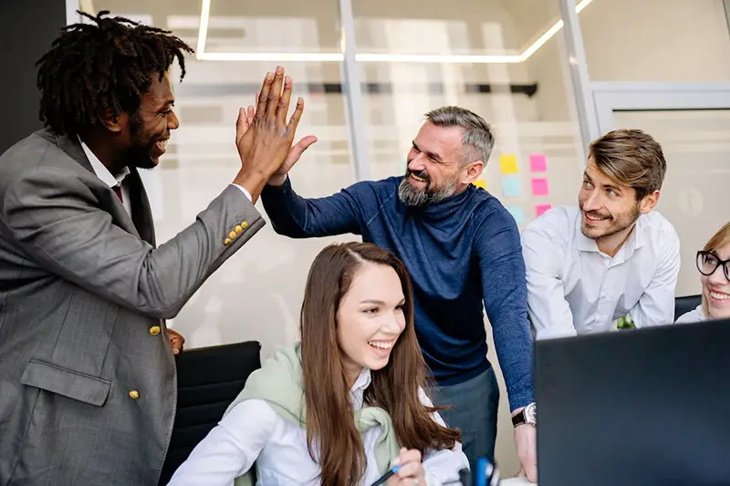 Happy employees giving high five