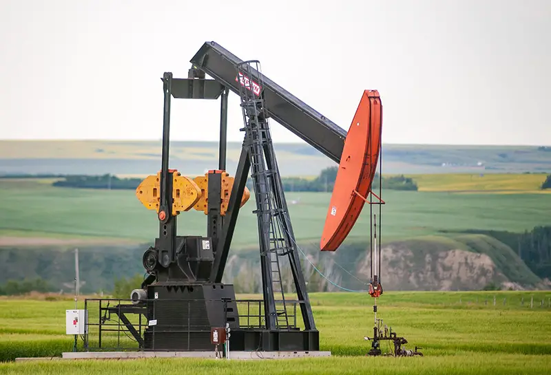 Black and orange metal machine in an oilfield