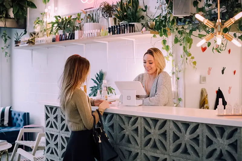 Woman in the cashier talking to her customer