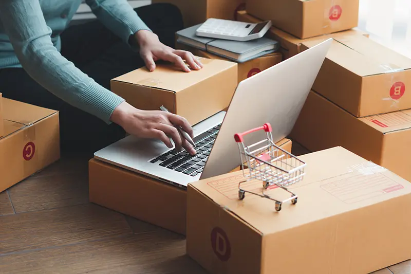 Person arranging brown parcel boxes