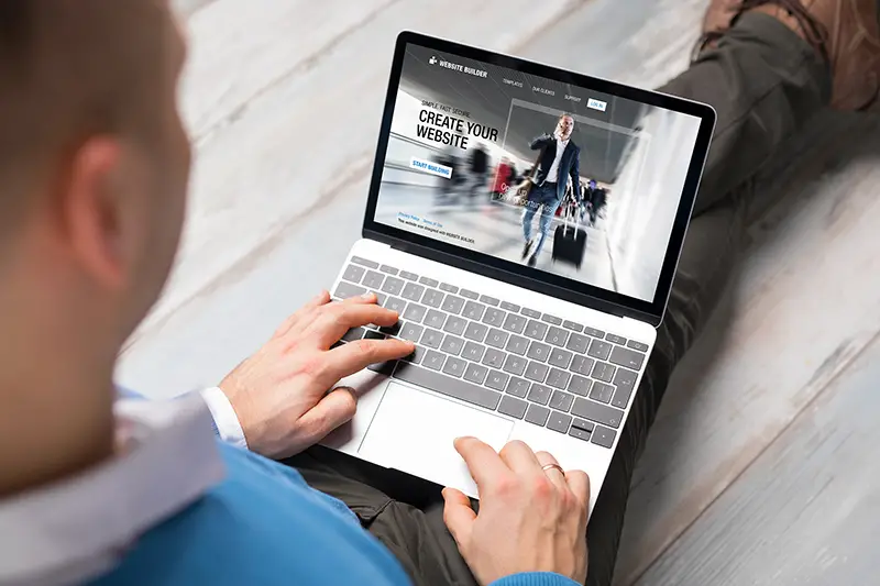 Man creating website for his business by using laptop computer