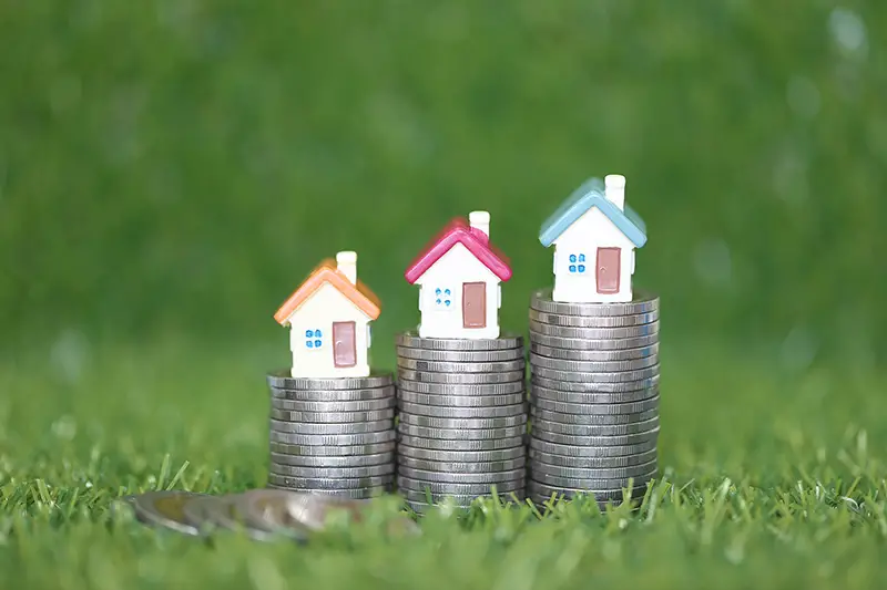 Finance, Model house on Stack of coins money on natural green background