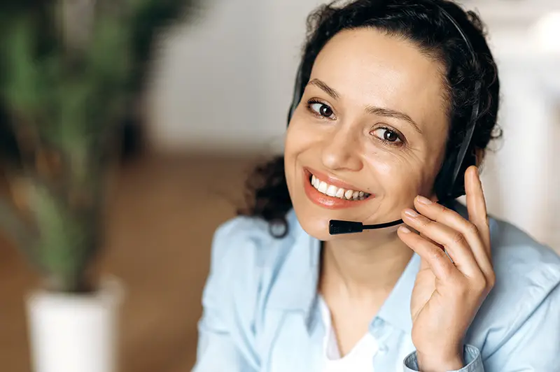 Close-up of mixed race attractive confident adult woman in headset,