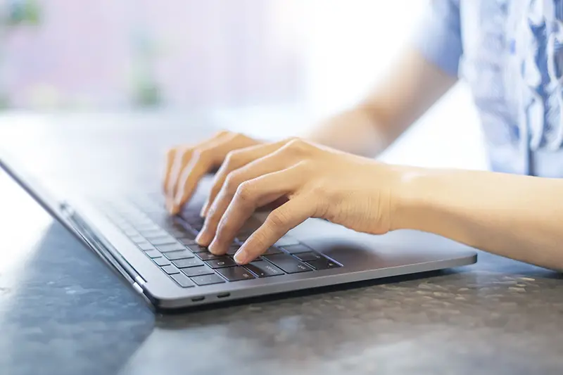 female hands typing on keyboard