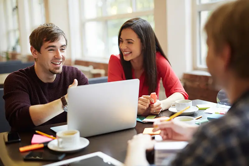 Employees brainstorming and sharing ideas in cafe