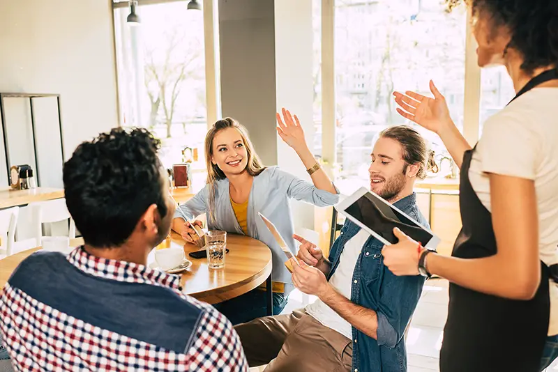 Waitress taking orders from clients