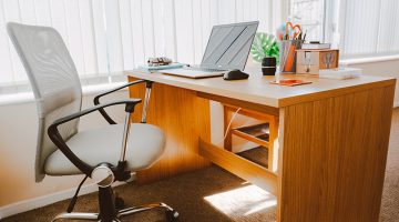 White Rolling Armchair Beside Table