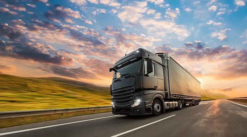 Truck with container on highway