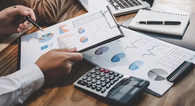 Cropped businessman holding clipboard with business financial report