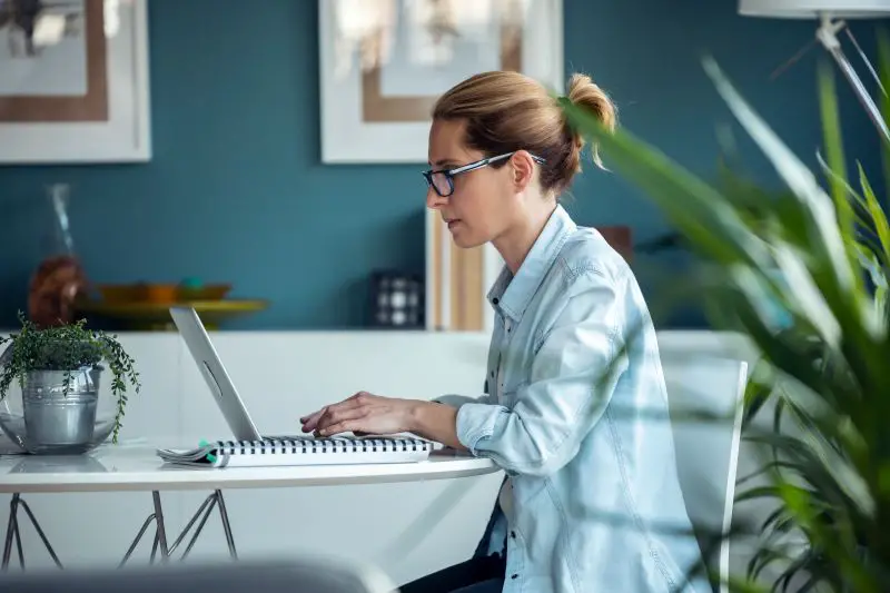 Concentrated mature business woman working with her computer in the office.