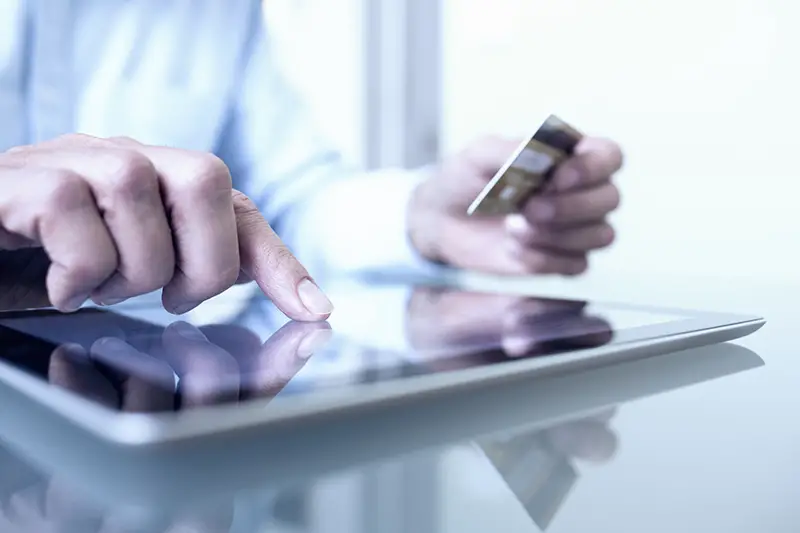 Man holding tablet pc and credit card