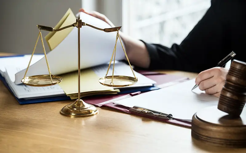 Judge at workplace with hammer and scale