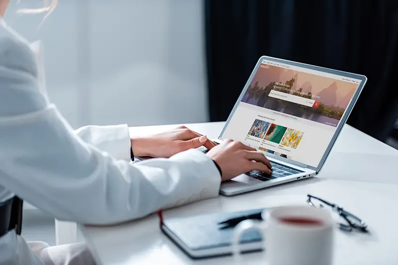 Woman using laptop browsing on business website