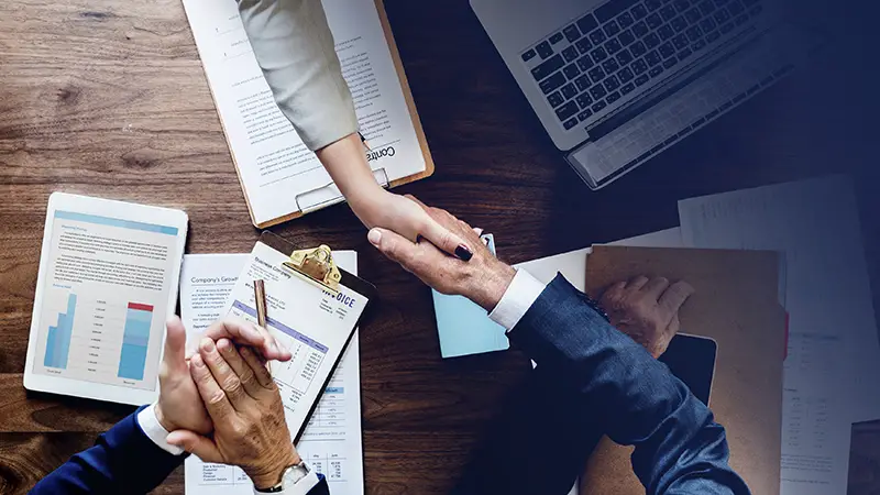 Business people shaking their hands