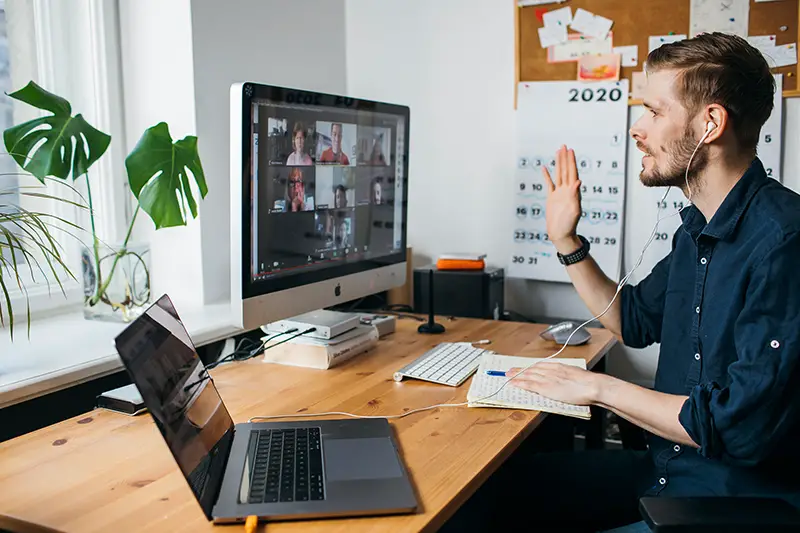 Young man having Zoom video conferencing call via computer