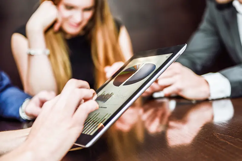 Business team using tablet computer to work with financial data