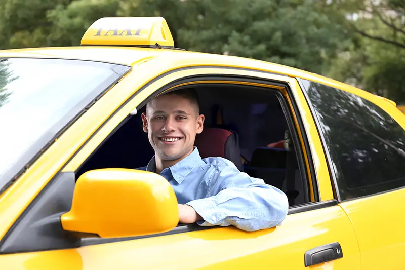 Male taxi driver in car