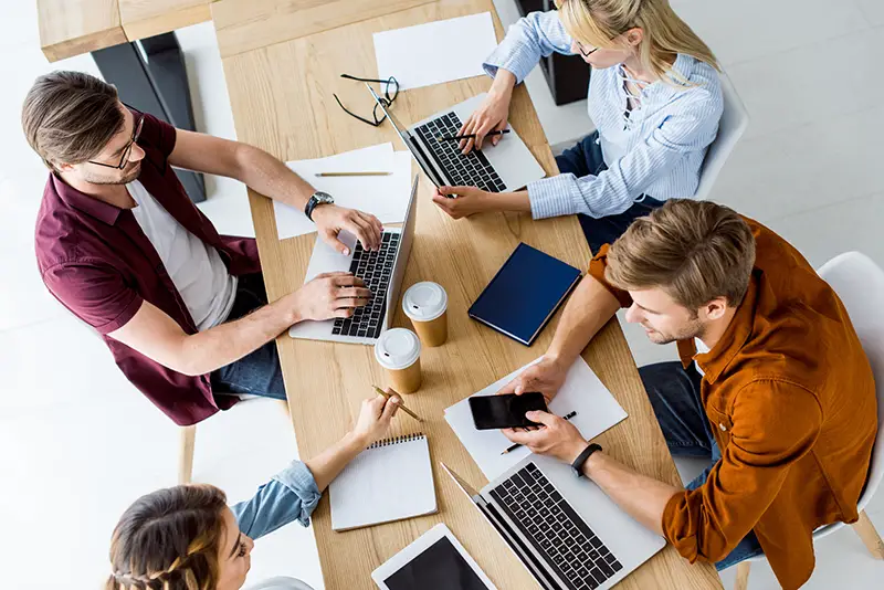 High angle view of colleagues working on startup