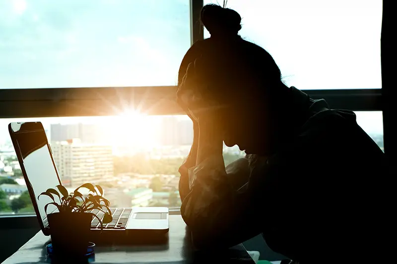 Stressed woman sitting in front of her desk