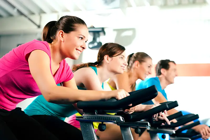 Group of four spinning inside the gym