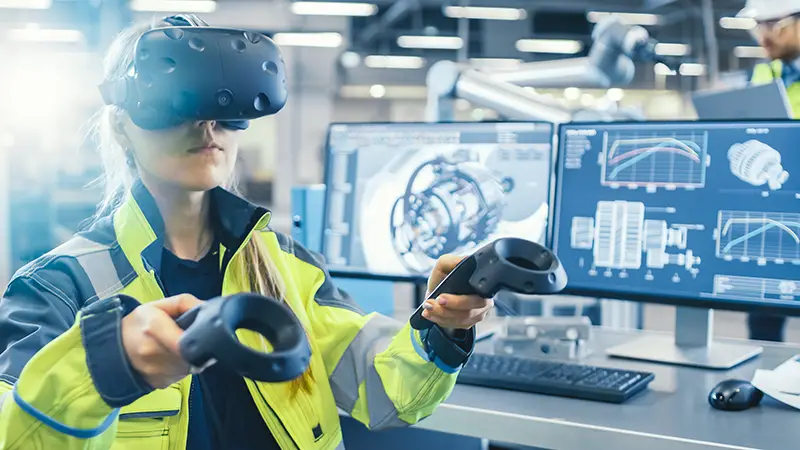 Female Industrial Engineer Wearing Virtual Reality Headset and Holding Controllers,