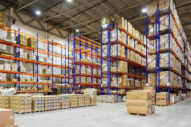 Interior of a modern warehouse storage of retail shop with pallet truck near shelves