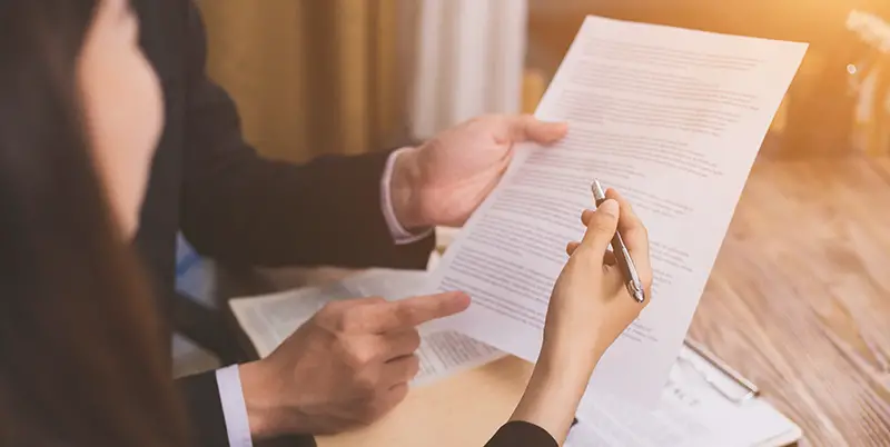 Female lawyer signing a document