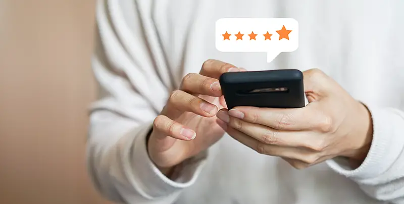 Customer giving five star rating feedback using smartphone