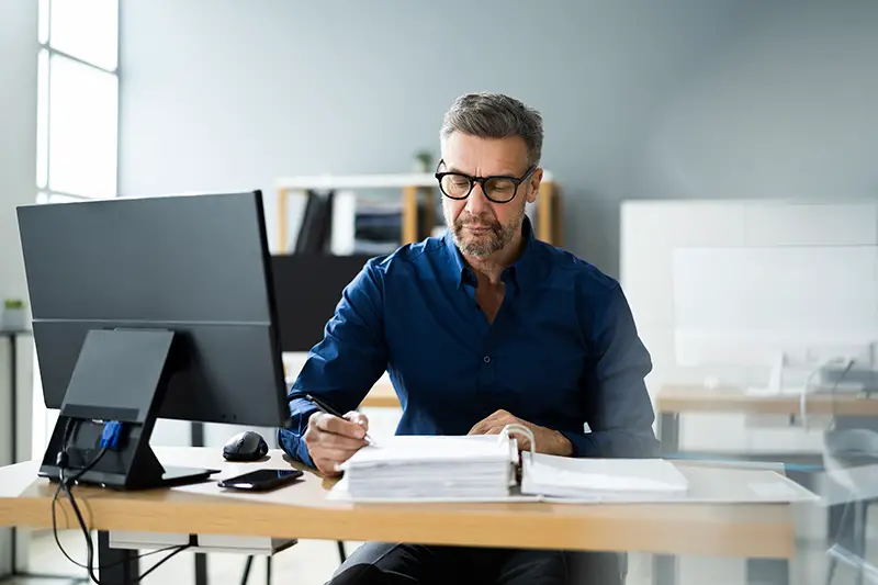 Businessman working on documents on his desk