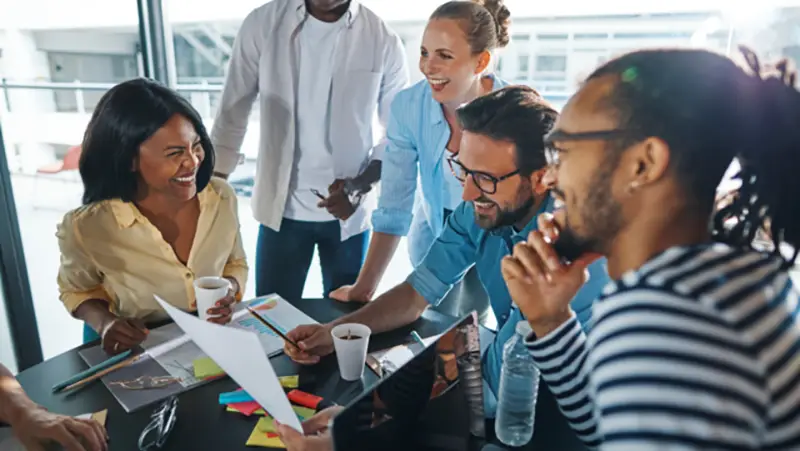 Happy diverse employees working in a project