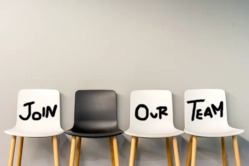 Job recruiting advertisement represented by 'JOIN OUR TEAM' texts on the chairs.