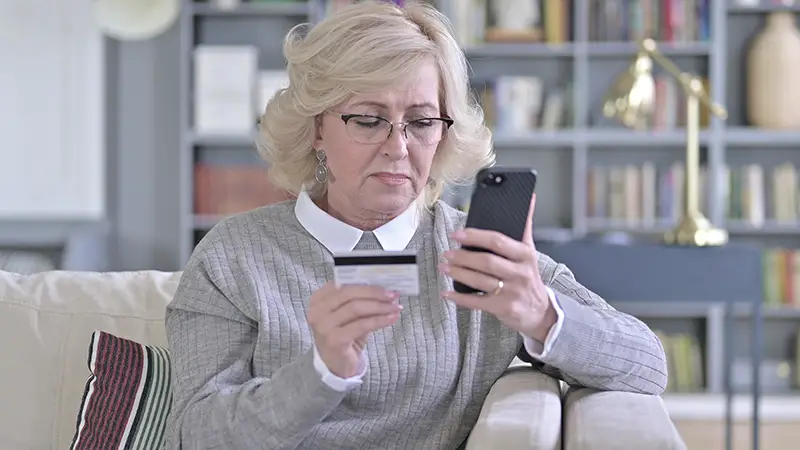 Senior woman using smartphone for onlinre payment