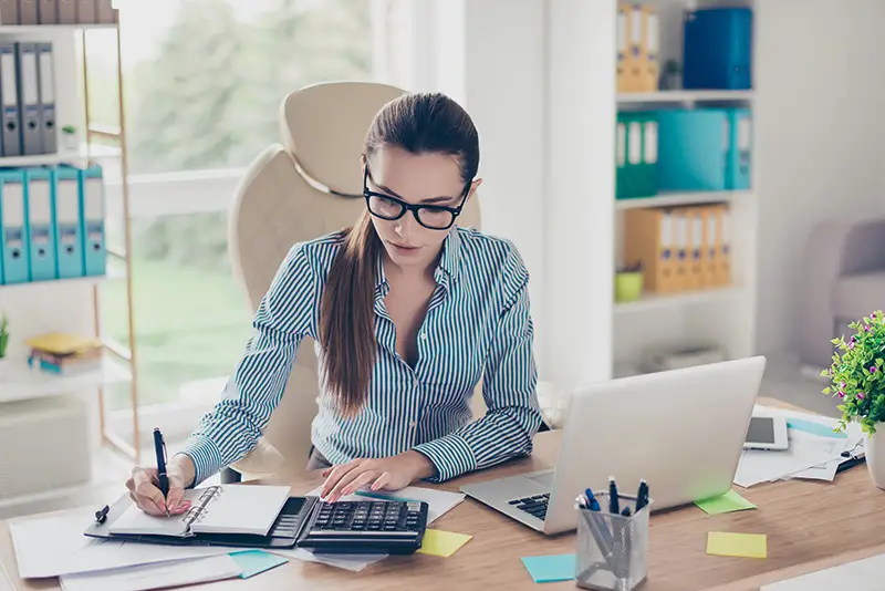 Portrait of serious young businesswoman accountant in formal wear