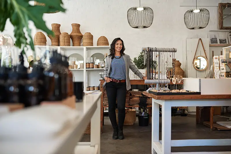 Business owner standing by a counter inside her shop