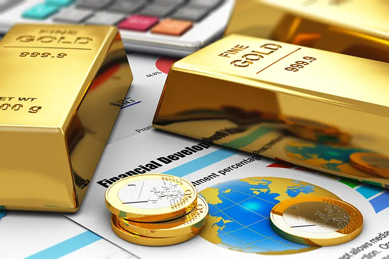 Gold ingots and coins on financial reports