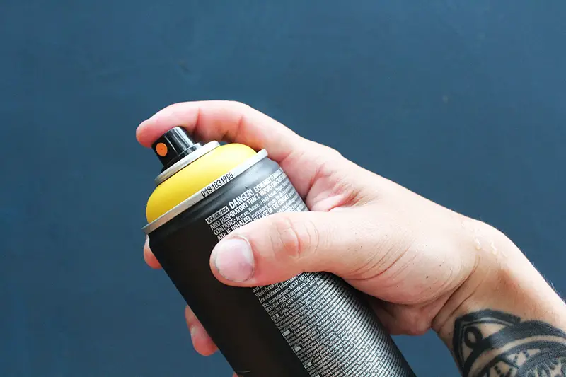 Person using aerosol can spray