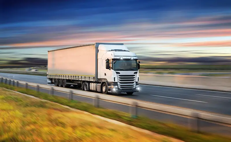 Truck with container on highway