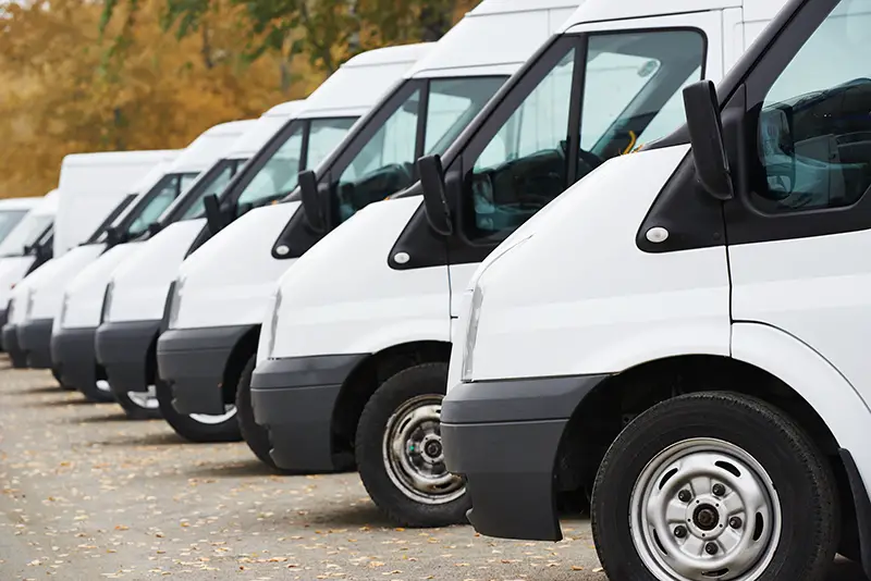 commercial delivery vans in row at parking place