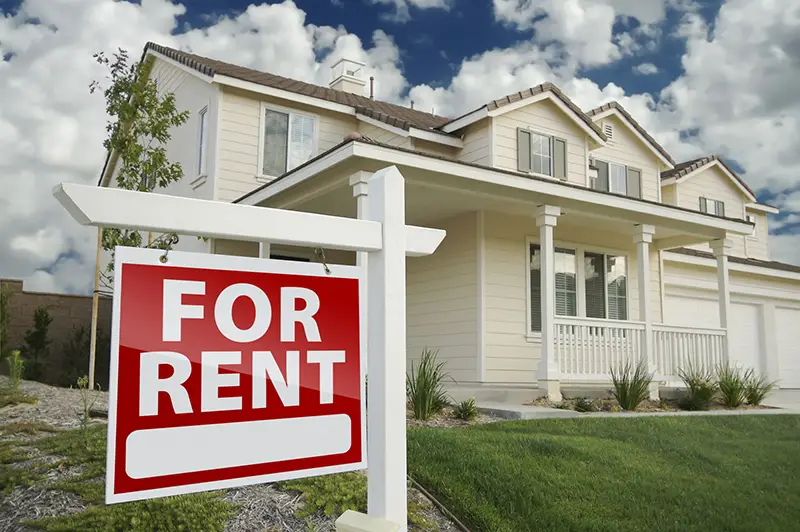 For Rent Real Estate Sign in Front of House