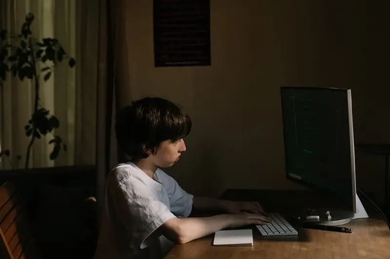 Young boy using computer for coding