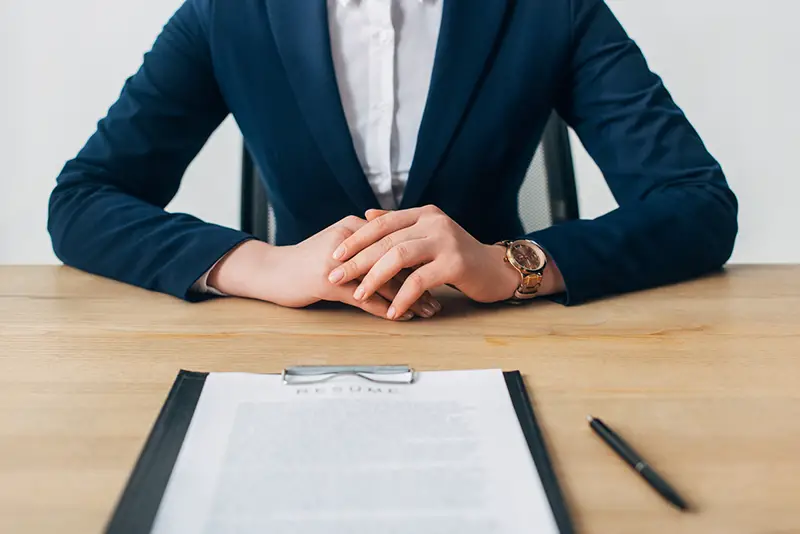 Cropped view of recruiter sitting near clipboard