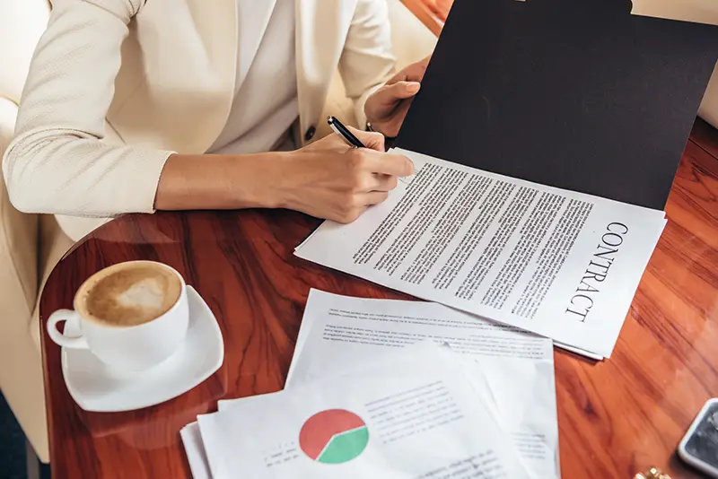 businesswoman in suit signing a contract