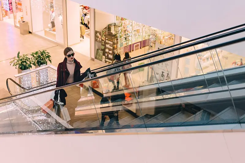 Woman inside the shopping mall using elevator