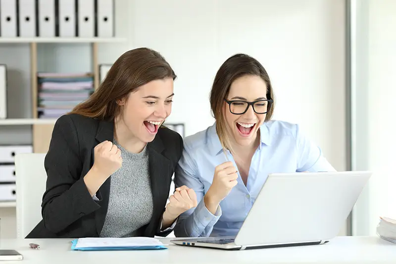 Two excited executives celebrating success