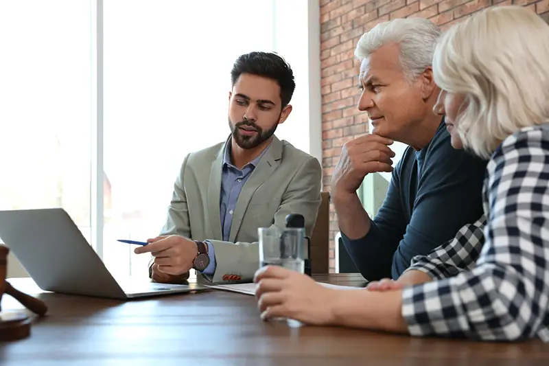 Male notary working with mature couple in office